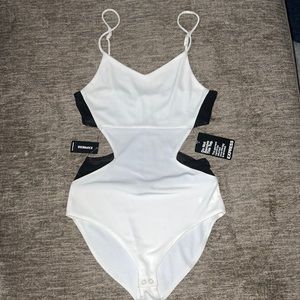 Black mesh and white cutout body suit with gold zipper on back